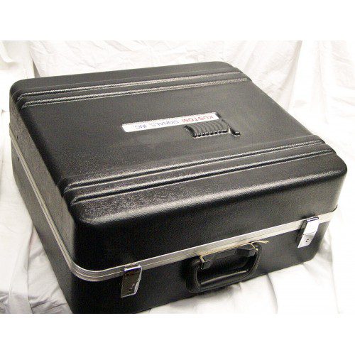 A black suitcase sitting on top of a white sheet.