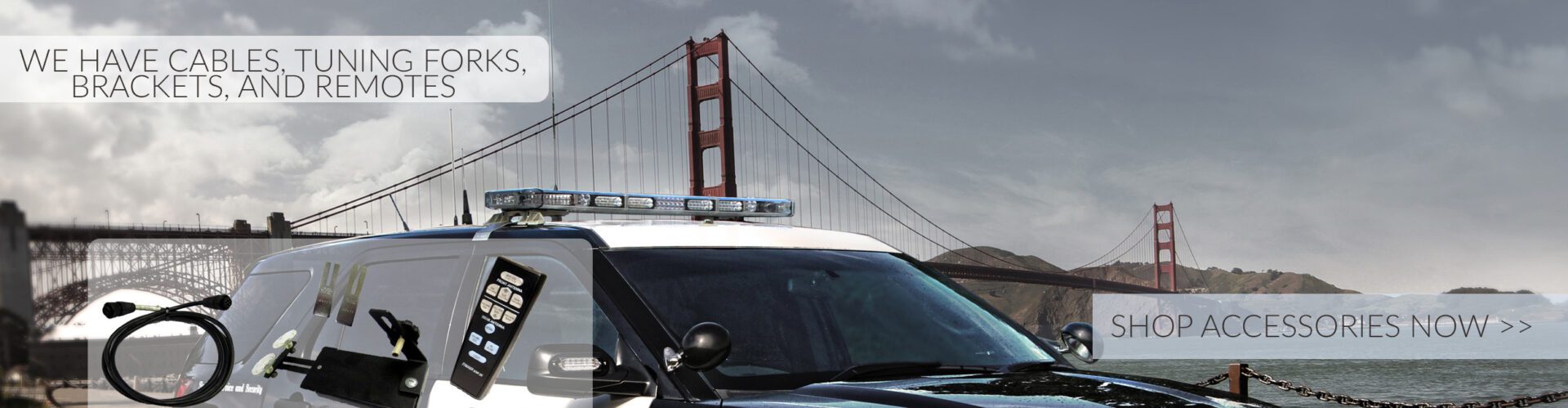 A police car parked in front of the golden gate bridge.