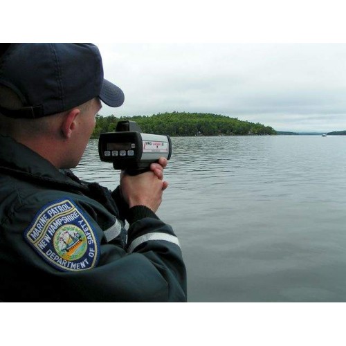 A police officer is taking pictures of the water.