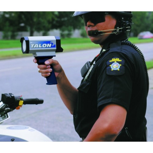 A police officer is holding a speed gun.