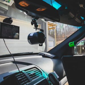 A car dashboard with two cameras on the side of it.