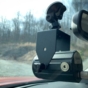 A car camera is mounted to the side of the windshield.