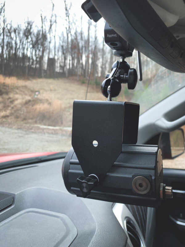 A car camera attached to the side of a vehicle.