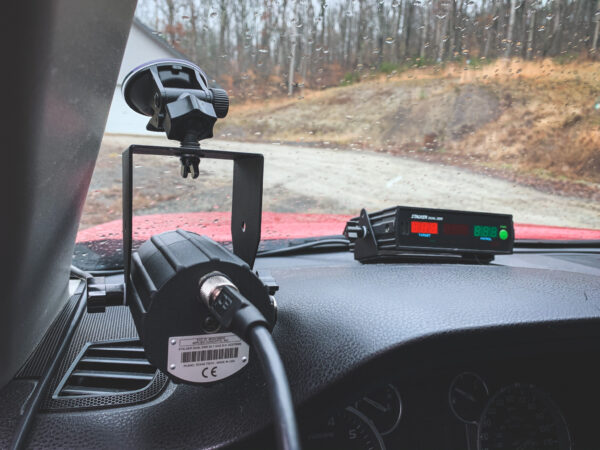 A dashboard with a car camera and a radio