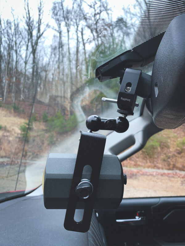 A camera mounted to the side of a car window.