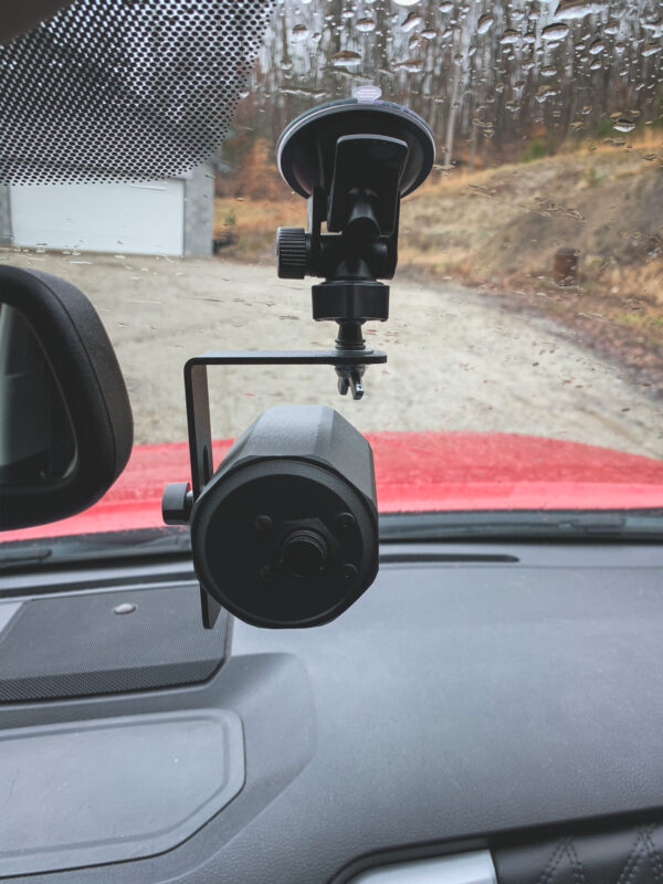 A car mirror with two cameras attached to it.