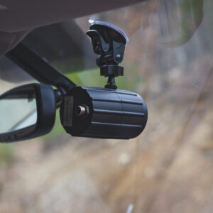 A car mirror with a camera attached to it.